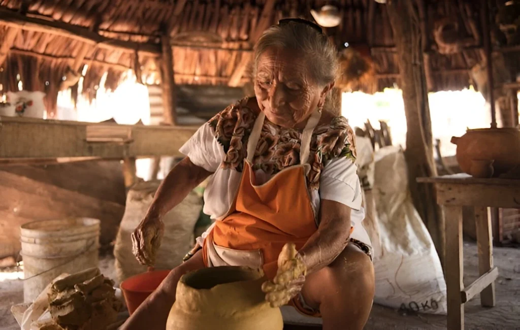 woman making ceramic piece using traditional techniques